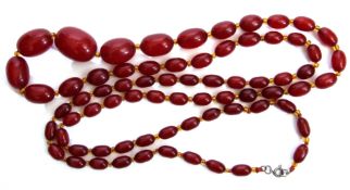 Vintage cherry amber necklace, a long single row of graduated oblong beads, 1cm to 3cm, interspersed