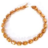 9ct stamped citrine line bracelet featuring 21 oval faceted citrines, each claw set and raised in