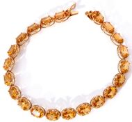 9ct stamped citrine line bracelet featuring 21 oval faceted citrines, each claw set and raised in