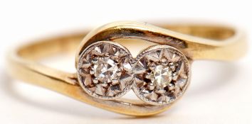 Antique diamond cross over ring featuring 2 small brilliant cut diamonds in illusion settings,