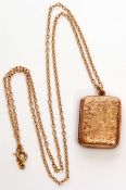 9ct gold rectangular locket, the front engraved with a foliate design, 2.5 x 1.5cm, suspended from a