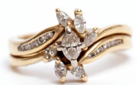 Modern diamond cluster cross-over ring, with seven marquise cut diamonds raised on diamond set