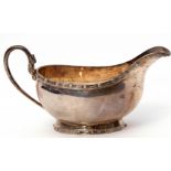 Elizabeth II small sauce boat with applied Celtic rims, serpent headed solid looped handle,