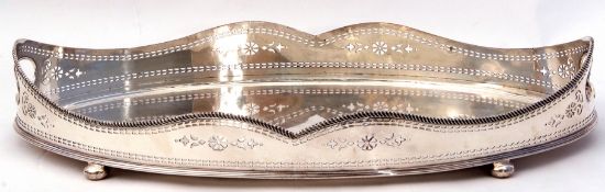 Silver plated galleried tray, with a hipped beaded surround and raised on compressed bun feet, circa