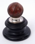 Silver mounted cricket trophy in the form of a mounted cricket ball on ebonised socle, the silver