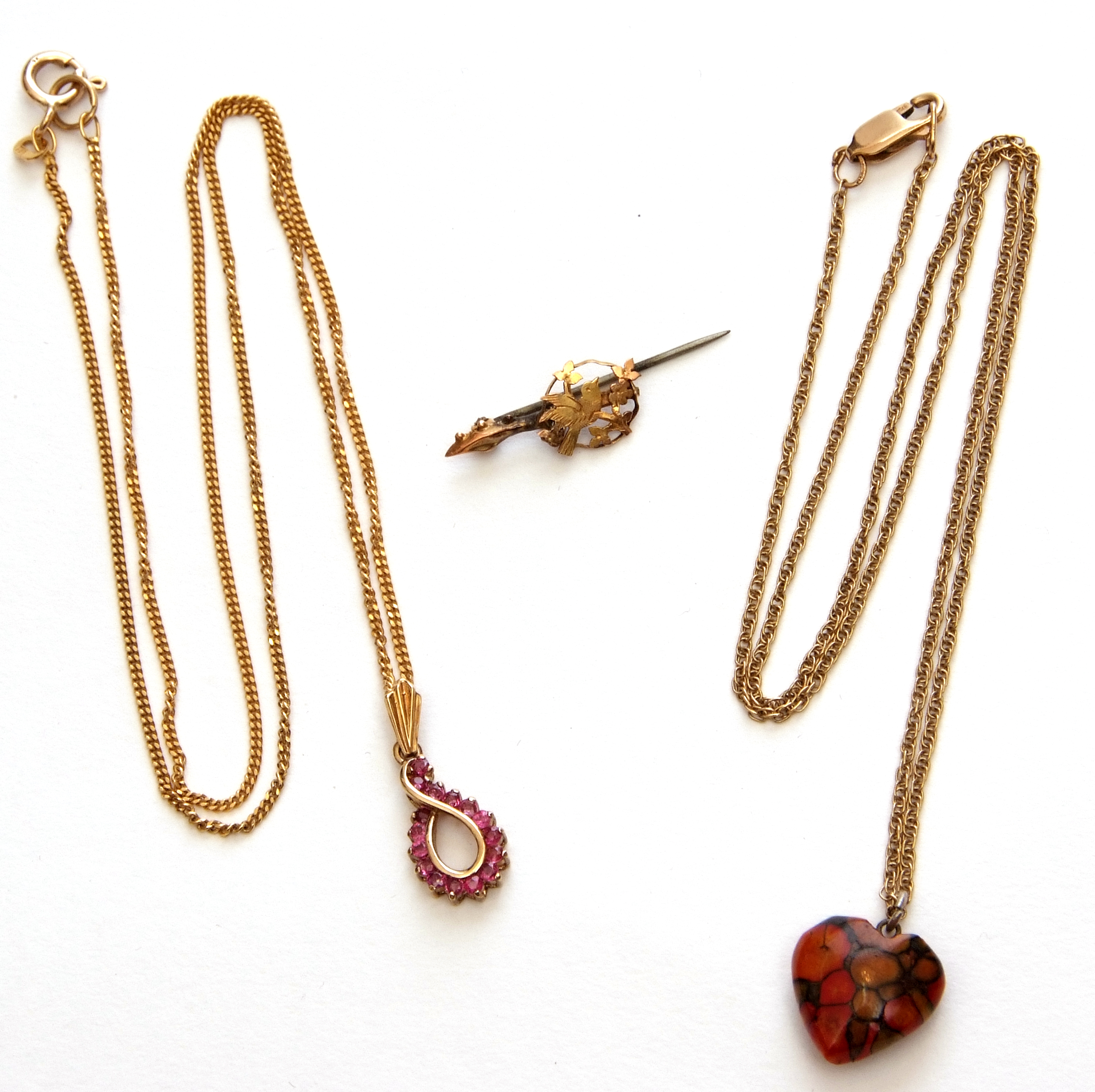 Mixed Lot: modern 9ct gold and ruby pendant on a 9kt stamped trace chain, a 9ct gold trace chain