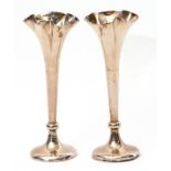 Small pair of Edwardian specimen vases on knopped tapering stems with fluted tops, circular loaded