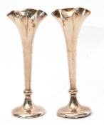 Small pair of Edwardian specimen vases on knopped tapering stems with fluted tops, circular loaded