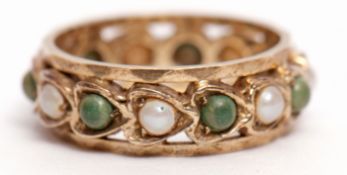 9ct gold eternity ring alternate set with seed pearls and green stones in a Celtic style, size J