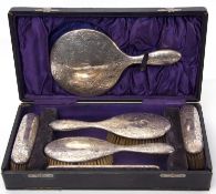 Cased six piece dressing table set comprising a hand mirror, two hair brushes, two clothes