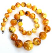 Vintage yellow yolk amber bead necklace of graduated design, 1cm to 2.5cm, 67gms