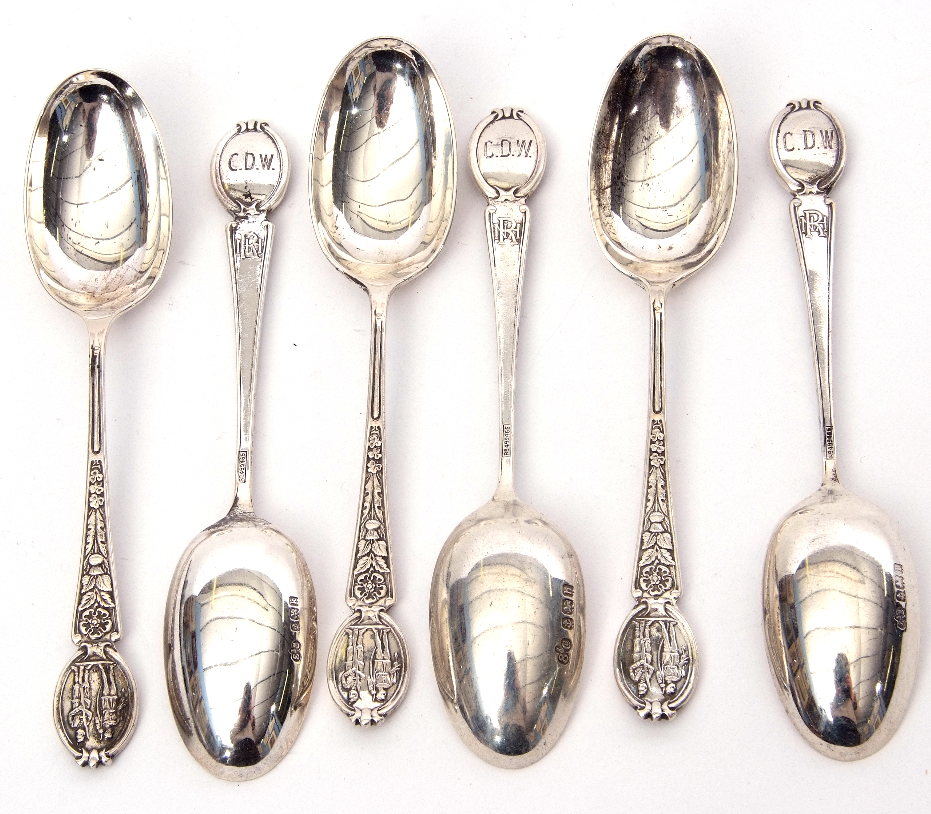 Set of six George V heavy tea spoons, the handles embossed with flowers and historic military - Image 2 of 2