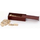 19th/20th century mahogany cased set of miniature bone dominoes, the case measuring 6cm x 2cm x 1.