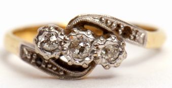 Antique three stone diamond cross over ring featuring 3 graduated old cut diamonds and highlighted