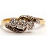 Antique three stone diamond cross over ring featuring 3 graduated old cut diamonds and highlighted