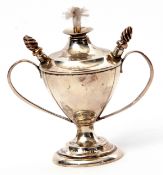 Edward VII table lighter of trophy vase shape to a circular foot, having twin looped handles,