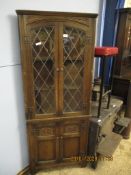 OAK CORNER CUPBOARD WITH LEADED AND GLAZED DOOR OVER CARVED PANELLED CUPBOARD DOOR