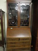 EDWARDIAN MAHOGANY BUREAU BOOKCASE WITH TWO ASTRAGAL GLAZED DOORS OVER DROP FRONT WITH TWO DRAWERS