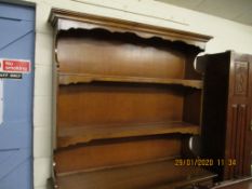 TEAK EFFECT DRESSER WITH TWO FIXED SHELVES, THE BASE WITH THREE DRAWERS OVER THREE PANELLED CUPBOARD