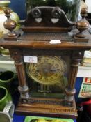 WALNUT CASED MANTEL CLOCK WITH CARVED DETAIL