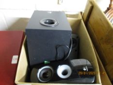 BOX CONTAINING A SMALL LOGITECH SPEAKER AND SMALLER PORTABLE SPEAKERS