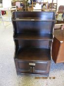 DARK STAINED POSSIBLY ERCOL WATERFALL FRONT BOOKCASE WITH TWO CUPBOARD DOORS WITH TURNED HANDLES