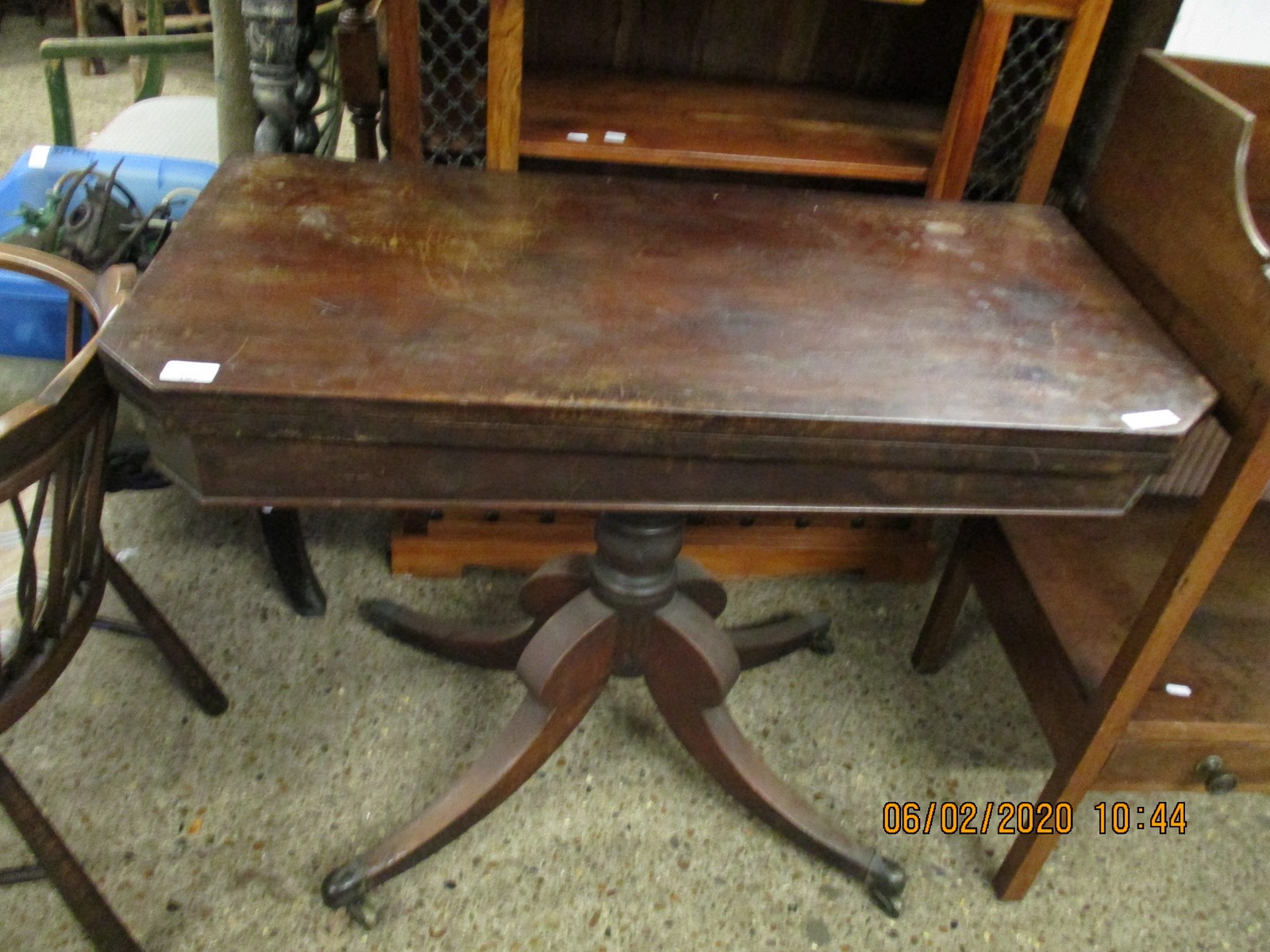 REGENCY MAHOGANY FOLD OVER CARD TABLE WITH TURNED COLUMN ON A QUATREFOIL BASE