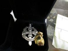 MINIATURE PENDANT HAND GRENADE AND A FURTHER CAP TYPE BADGE OR BROOCH
