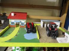 PAINTED MODEL OF A FARM AND TWO TRACTORS