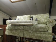 GOOD QUALITY GREEN AND CREAM FLORAL UPHOLSTERED TWO-SEATER SOFA AND RECTANGULAR FOOT STOOL (2)