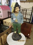 RESIN PAINTED FIGURE OF A YOUNG BOY WITH A HAND IN HIS POCKETS
