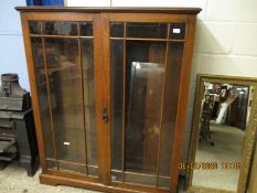 OAK FRAMED TWO GLAZED DOOR ADJUSTABLE SHELF BOOKCASE