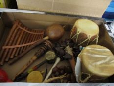 BOX CONTAINING MIXED AFRICAN MUSICAL INSTRUMENTS, WIND PIPES, DRUMS ETC