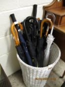 WHITE WICKER BASKET CONTAINING MODERN UMBRELLAS ETC