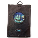 Arts & Crafts metal plaque with planished finish, the centre inset with an enamel plaque of a