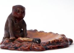 Unusual Bretby dish modelled with a monkey with glass eyes and a cigarette on a brown pottery