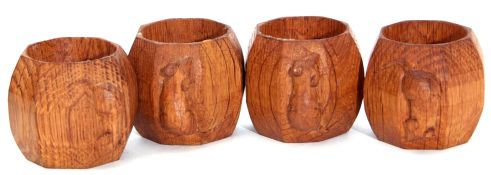 Set of four 20th century Robert Thompson Mouseman carved napkin rings of octagonal form with the
