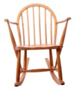 Unusual mid-20th century blonde wood Ercol child's rocking chair with spindle back supports, 74cm