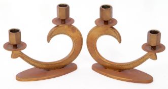 Pair of shaped brass candlesticks holders, 18cm wide