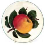 Small Wemyss ware plate with factory mark to base, decorated with an apple amongst green foliage,