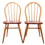 Two mid-20th century blonde wood Ercol chairs with spindle back supports and tapering legs, 86cm