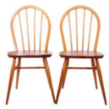 Two mid-20th century blonde wood Ercol chairs with spindle back supports and tapering legs, 86cm