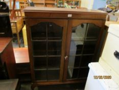 19TH CENTURY MAHOGANY BOOKCASE WITH TWO GLAZED DOORS RAISED ON CLAW AND BALL FEET