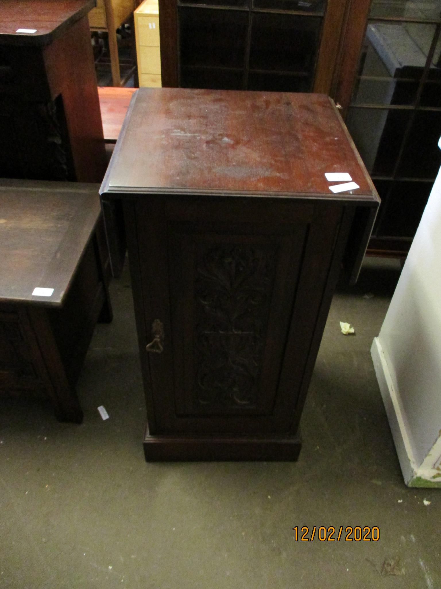 EDWARDIAN WALNUT BEDSIDE CUPBOARD WITH SINGLE CARVED DOOR WITH DROP LEAF TOP