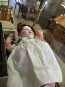 VINTAGE DOLL IN LACED CLOTHING AND BONNET