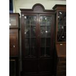 EDWARDIAN MAHOGANY BOOKCASE WITH TWO LEADED AND GLAZED DOORS OVER TWO PANELLED CUPBOARD DOORS WITH
