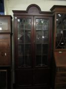 EDWARDIAN MAHOGANY BOOKCASE WITH TWO LEADED AND GLAZED DOORS OVER TWO PANELLED CUPBOARD DOORS WITH