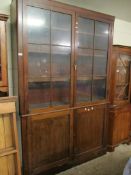 GEORGIAN MAHOGANY BOOKCASE WITH TWO GLAZED SECTIONAL DOORS OVER TWO PANELLED CUPBOARD DOORS