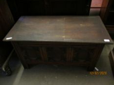EARLY 20TH CENTURY OAK LIFT UP TOP COFFER WITH GEOMETRIC PANELLED FRONT
