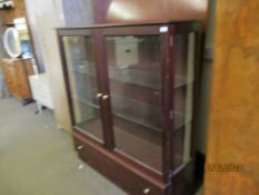 TEAK FRAMED TWO GLAZED DISPLAY CABINET WITH FULL WIDTH DRAWER TO BASE WITH BRASS BUTTON HANDLES